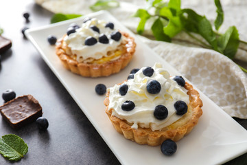 Delicious blueberry tarts on plate