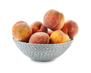 Bowl with fresh peaches on white background