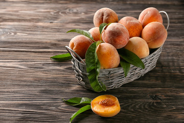 Naklejka na ściany i meble Basket with fresh peaches on wooden table