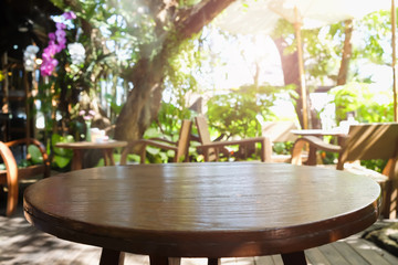 Empty wooden desk of free space and spring time with blurred background of home garden for a catering or food background,Template mock up for display montages of product.