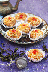 Oriental Algerian sweet cookies( mchawak   named in arabic ), tea cup and pot and mint leaves