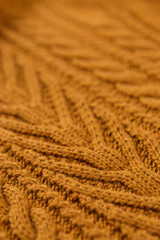 Closeup orange color cotton knitted textile with pattern as background