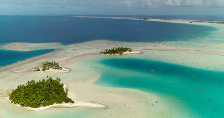 small islands (motu) in the middle of a lagoon in aerial view, French Polynesia