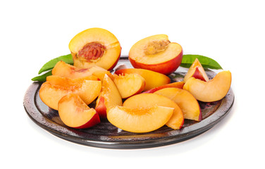 Plate with fresh peaches on white background