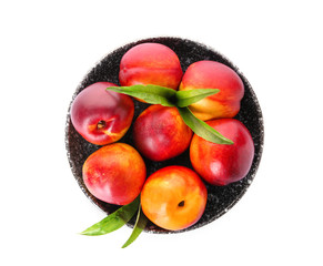 Plate with fresh peaches on white background