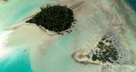 small islands (motu) in the middle of a lagoon in aerial view, French Polynesia