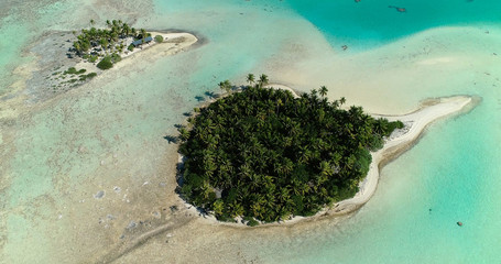 small islands (motu) in the middle of a lagoon in aerial view, French Polynesia