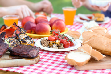 Table with tasty food prepared for summer picnic outdoors