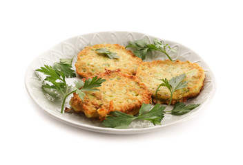Plate with zucchini pancakes isolated on white