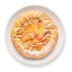 Plate with delicious peach galette on white background