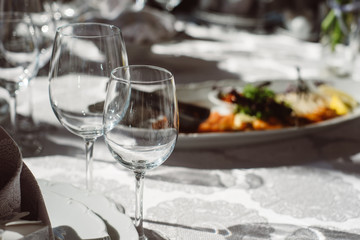 Crystal clear empty wine glasses on the table. Alcohol background. 