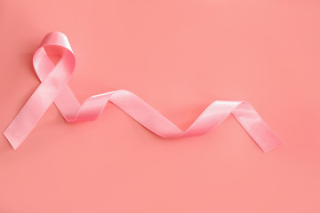 Pink ribbon on color background. Breast cancer awareness concept