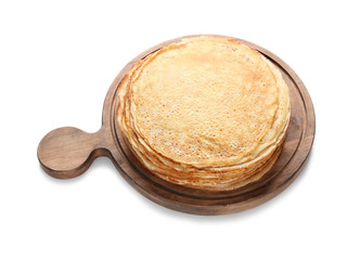 Board with tasty thin pancakes on white background