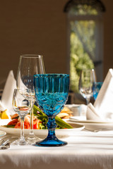 A blue glass for wine on the table in the restaurant