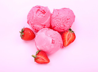 Tasty strawberry ice-cream balls on color background