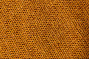 Knitted gold color textile as background