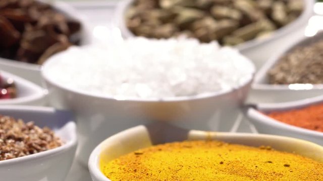 Dry spices on a rotary table. 4K. Macroshooting.