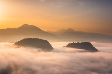 Sunrise over the Alps mountains at foggy morning in Bled, Slovenia