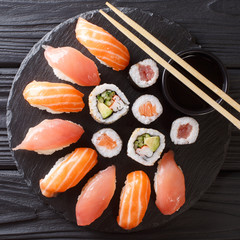 Japanese sushi on a rustic dark background. Sushi rolls, nigiri, maki, soy sauce. Sushi set on a table. Asian food. top view from above