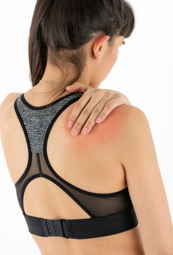 Isolated woman with a pain in a shoulders area
