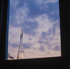 Glass bottle in window with sunset