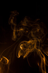 Gold smoke on black background.