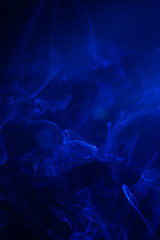 Blue smoke on black background.