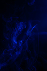 Blue smoke on black background.