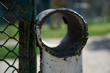 Steel mesh with metal rusty pipe, defocused background for web site or mobile devices
