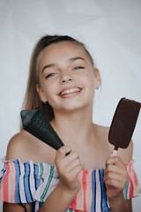 Happy girl eating ice cream. Young hipster girl eating a delicious ice cream in summer hot weathe. Chocolate. Cream. Ice. Sweet Tooth