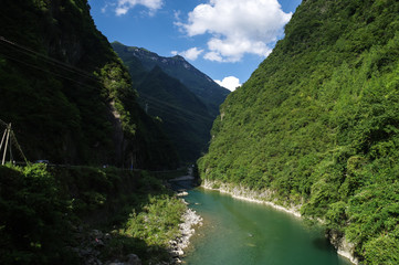 Fototapeta na wymiar Limpid Stream Between Two Mountains