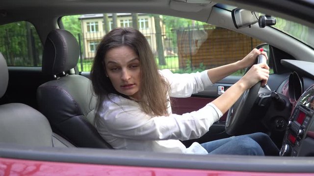 Unhappy woman arguing in car.