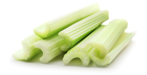heap of celery sticks isolated on white background