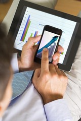 Close-up of a Businessman Analyzing Business Graphs on a