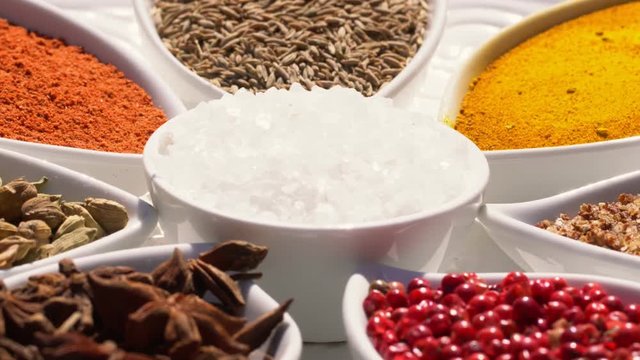 Dry spices on a rotary table. 4K. Macroshooting.