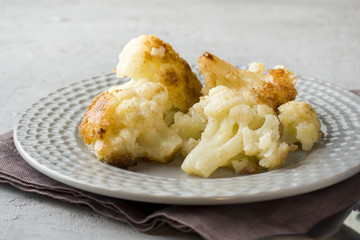 Florets of cauliflower batter fried in oil on the plate