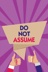 Writing note showing Do Not Assume. Business photo showcasing Ask first to avoid misunderstandings confusion problems Man woman hands thumbs up approval speech bubble rays background.