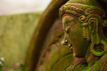 Statue of Goddess naked chest There are green moss on the body. 	