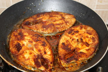 Seer fish being fried in Indian style on a metal pan. Also known as King fish.