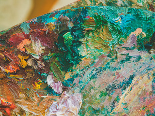Artists multicolored oil paints on wooden palette or canvas. Close up abstract background. Art...