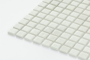 little white ceramic tile on a light background, majolica. for the catalog