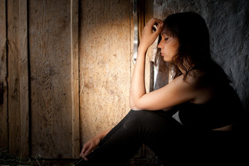 Fototapeta premium Teenager girl with depression alone in the dark room.