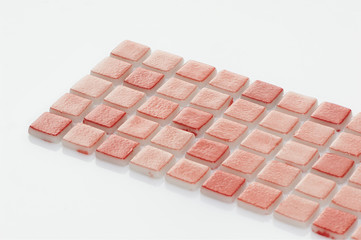 little brown ceramic tile on a white background, majolica. for the catalog