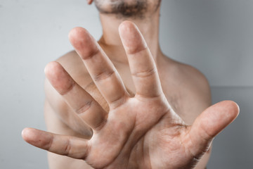 Close-up of hand raised to camera, gesture of stop. Conception of people's gestures, stop.