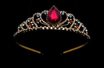 gold diadem with red ruby stone isolated on black - obrazy, fototapety, plakaty