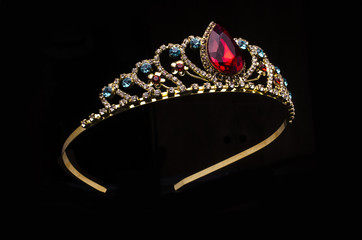 gold diadem with red ruby stone isolated on black - obrazy, fototapety, plakaty