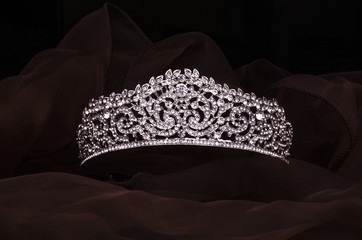 silver diadem with diamonds isolated on the fabric