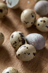 Top flatview of quail eggs on old wooden cutboard