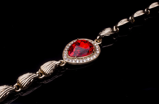 golden bracelet with ruby and diamonds isolated on black