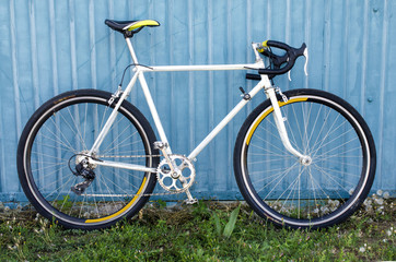 speed bike, road bike, against a blue wall